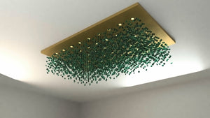 Design render of an emerald glass stone cloud chandelier under a matt gold rectangular canopy