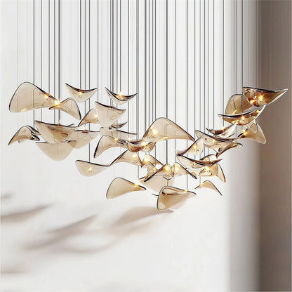 Artistic cluster of curved champagne-amber hand-formed glass wing pendants suspended at staggered heights