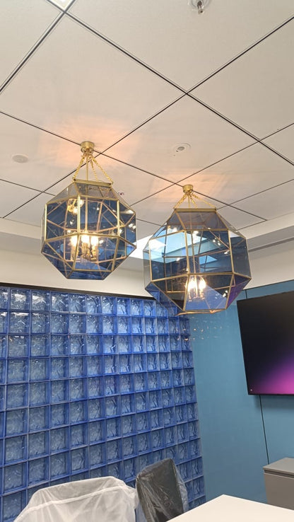 Custom brass and blue-tinted glass geometric pendants installed in a corporate meeting room, Hyderabad