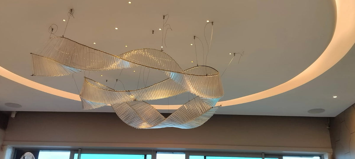 Crystal ribbon chandelier installed in a circular ceiling cove