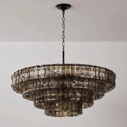Four-tiered round drum chandelier clad in wavy smoked-grey glass ribbons suspended on a black rod and chain