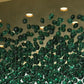 Design render close-up of green glass stones hanging below gold canopy with GU10 lights