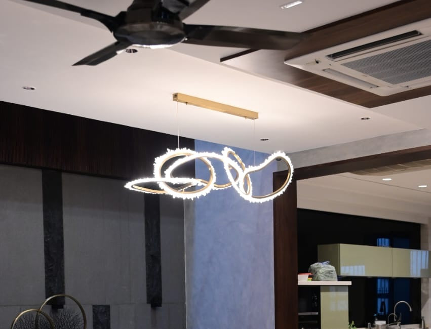LED ring chandelier of interlocking loops edged with crystals over the dining table