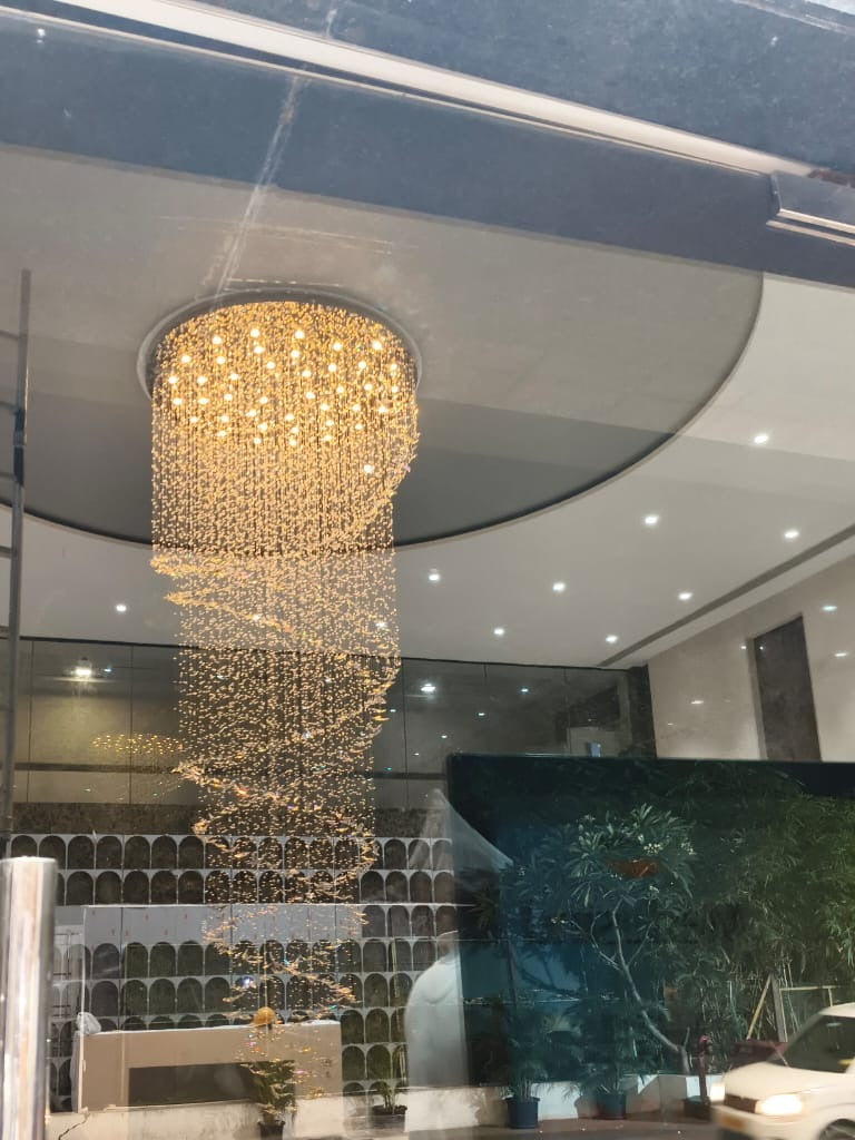 The spiral crystal chandelier seen through the glass entrance of the lobby, Chennai
