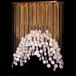 Angled view of the gold chain curtain and white hexagon tile arch chandelier showing recessed canopy downlights