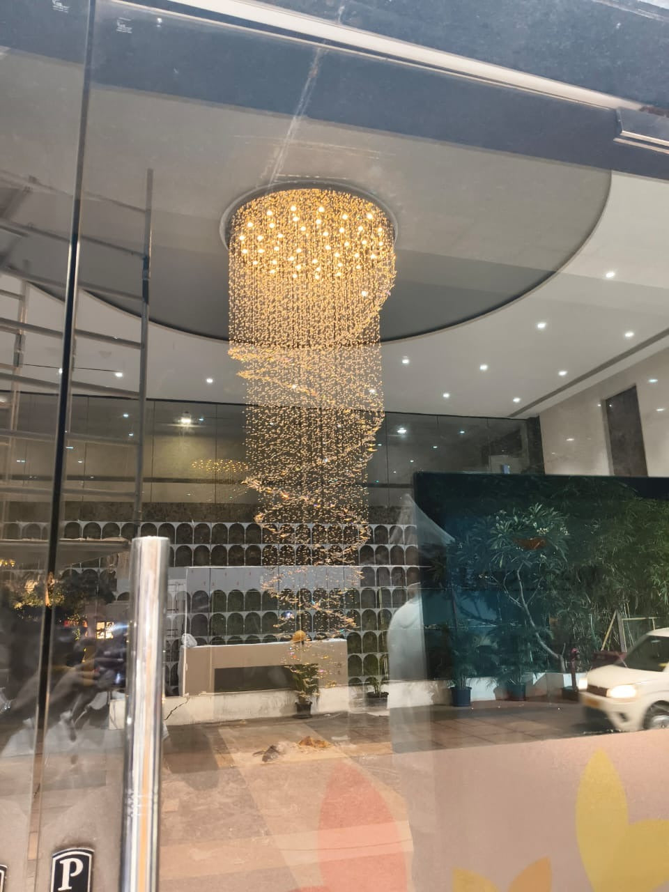 Spiral crystal butterfly chandelier seen through the glass entrance