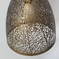Close-up detail of the antique brass shade highlighting the organic leaf-vein and cellular cutout pattern