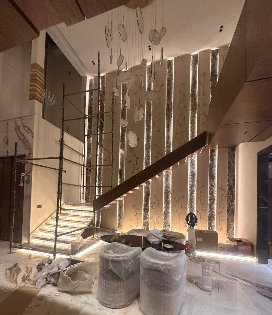 Double-height stairwell during finishing, with the lighting switched on