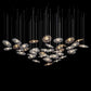 Horizontal cloud arrangement of suspended white and gold pierced hexagonal lattice discs glowing from below