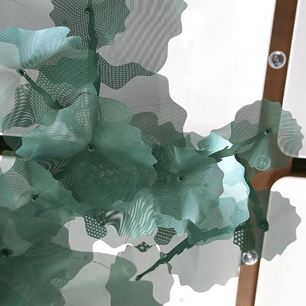 Upward view of overlapping translucent green wire-mesh lotus leaf discs suspended beneath a coffered ceiling