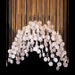 Close-up detail of the white veined hexagonal tiles, crystal bead connectors, and fine gold suspension chains