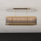 Design visual of the front elevation of the oval brass and fluted crystal rod chandelier with warm internal illumination