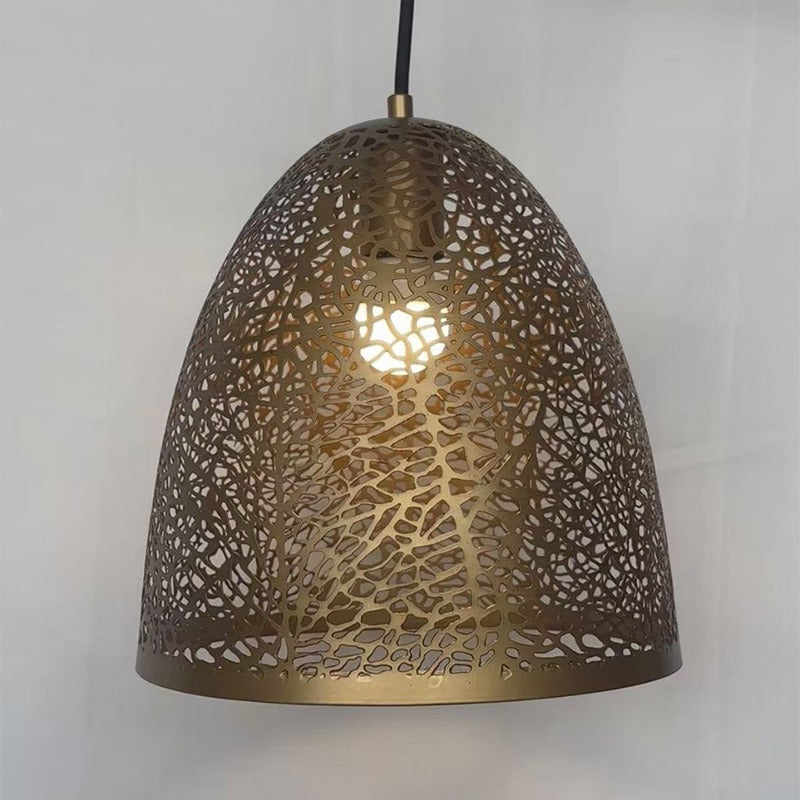 Front view of the lit perforated brass bell chandelier casting a warm glow through the cellular metalwork