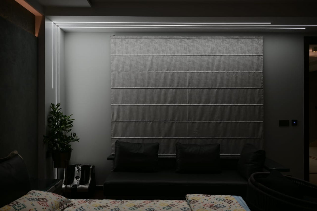 Recessed linear LED lines running up the wall and across the bedroom ceiling