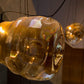 Close-up detail of hand-blown amber glass bubble texture and warm LED glow