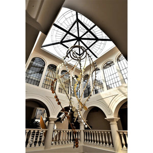 Brass Helix & Glass Disc Chandelier – A Sculptural Statement for Double-Height Atriums