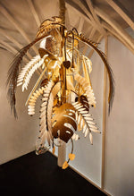 Antique brass palm-leaf and hand-blown glass chandelier, close-up hero view