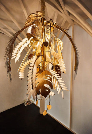 Antique brass palm-leaf and hand-blown glass chandelier, close-up hero view