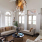 Chandelier installed in a double-height living room, wide environmental view