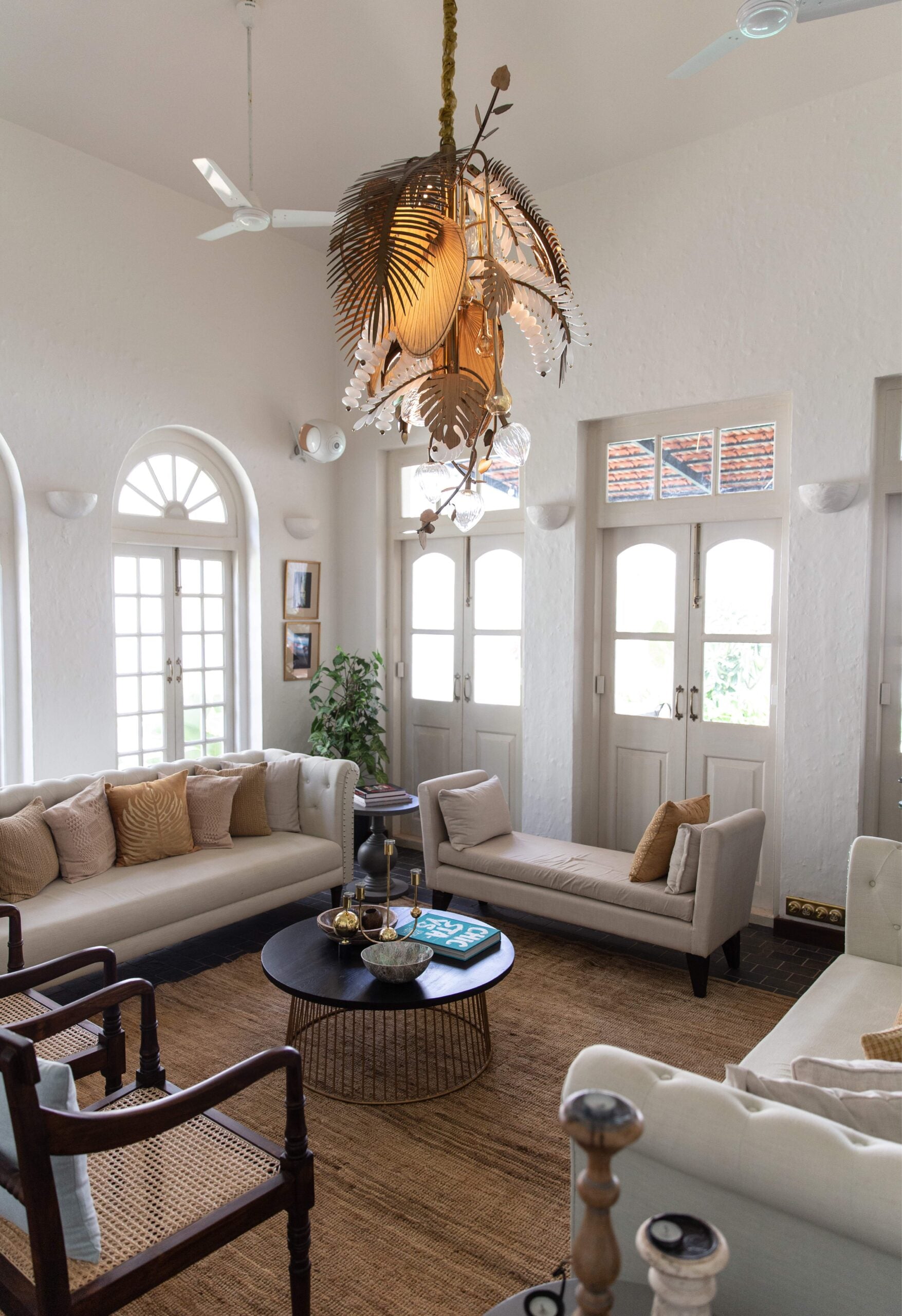 Chandelier installed in a double-height living room, wide environmental view
