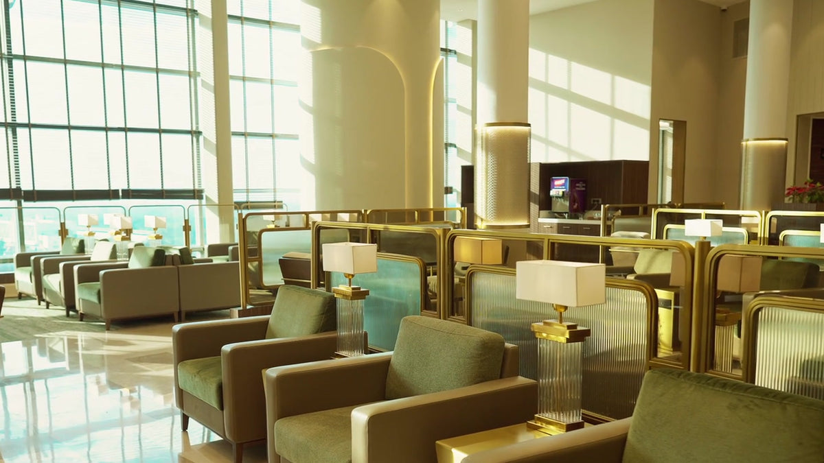 Custom glass-tube table lamps with rectangular shades in the Encalm Privé lounge (photo: Encalm Hospitality)
