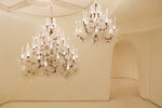 Iridescent frost leaf glass chandelier with candle-style LED diffusers, installed in a double-height space