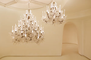 Iridescent frost leaf glass chandelier with candle-style LED diffusers, installed in a double-height space