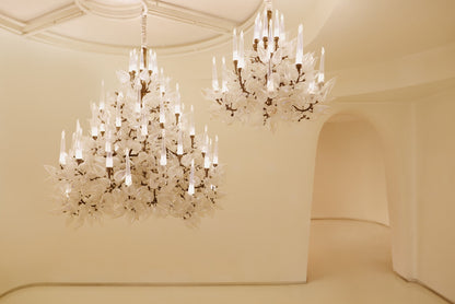 Iridescent frost leaf glass chandelier with candle-style LED diffusers, installed in a double-height space