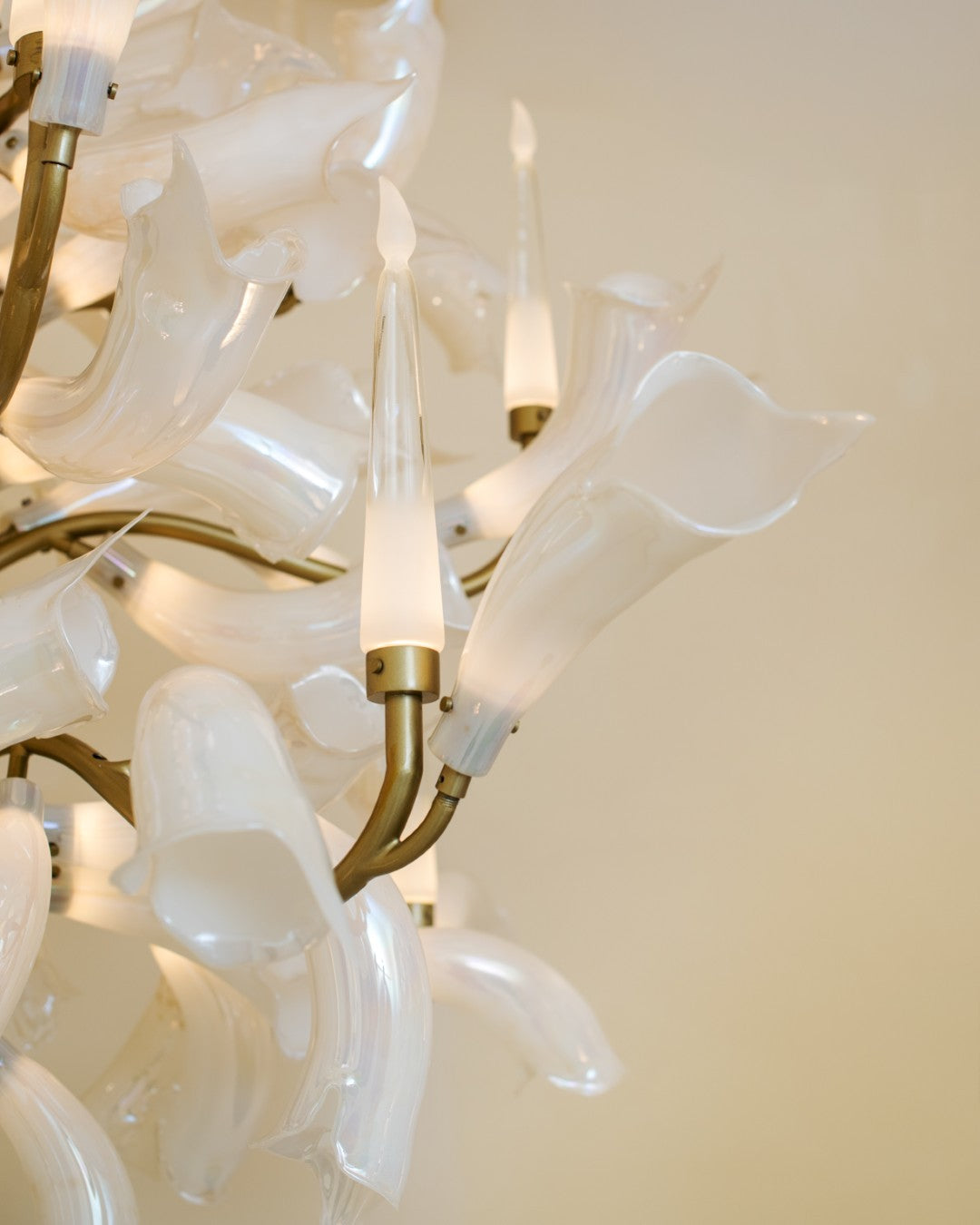 Close-up detail of hand-blown opalescent glass petals on the chandelier