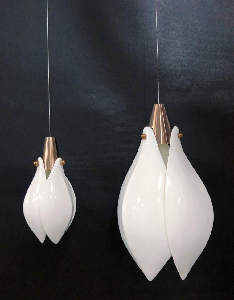 Close-up of the frosted opal glass drop with brushed copper finial