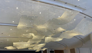 Close view of the rippling crystal-tile mesh chandelier catching light