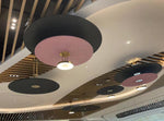 Pleated disc drum pendant chandelier in two-tone finish over a retail ceiling