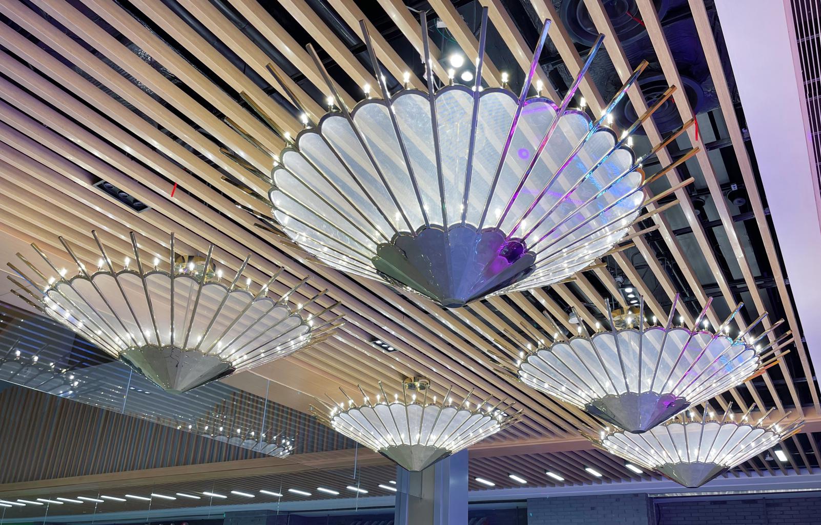 Close-up of the fan blade pendant chandelier showing radiating metal spokes