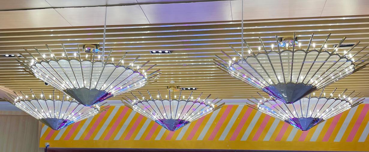 Row of fan blade pendant chandeliers hung at varied heights