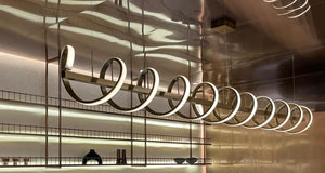 Close-up of the spiral LED ribbon chandelier's looping metal form