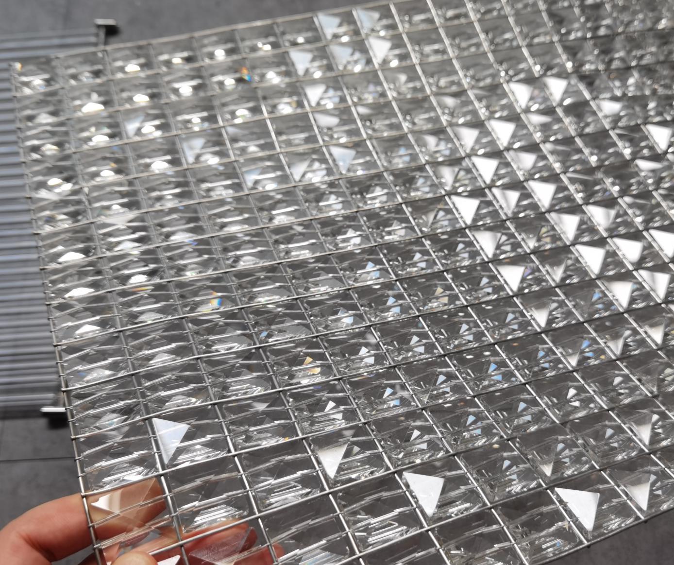 Close-up of faceted crystal tile texture on the wave chandelier panel