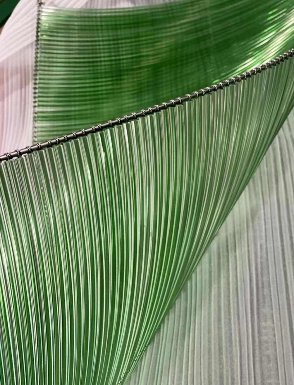 Close-up of the ombre strand ribbon material transitioning from clear to green