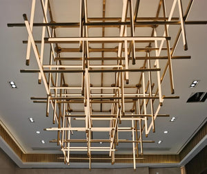 Underside view of the crosshatch brass linear beam chandelier grid