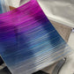 Close-up of the magenta-to-blue ombre strand ribbon material