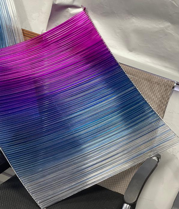 Close-up of the magenta-to-blue ombre strand ribbon material