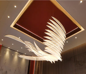Soaring plumage LED sculptural chandelier swept across a recessed ceiling coffer