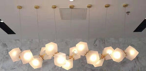 Frosted glass gem cluster pendant chandelier over a marble counter