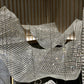 Folded crystal mesh sail chandelier billowing across an atrium ceiling