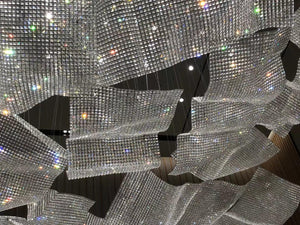 Close-up detail of the folded crystal mesh panels catching light