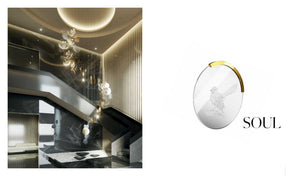SOUL suspension collection hero – engraved crystal disc pendant over a staircase in a dark marble interior