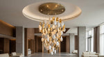 Pearl White & Gold Disc Cascade Chandelier - a custom cylindrical disc chandelier in a double-height lobby