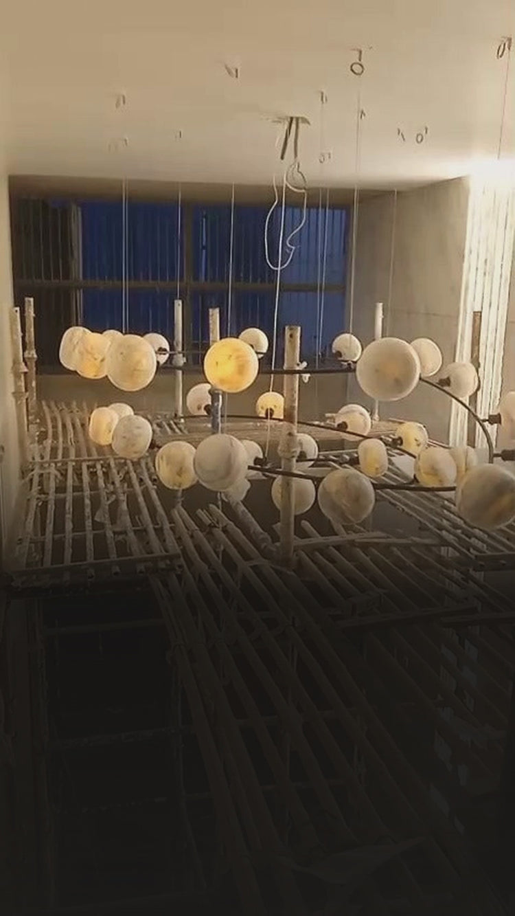 Marble globe spiral chandelier lit at installation – residence, Defence Colony, New Delhi – project reel