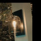 Exposed-bulb wall light on the resort’s feature stone wall