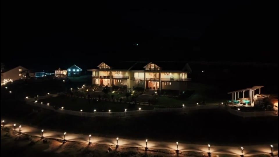 The Golden Meadows Resort fully lit at night with pathway and landscape lighting
