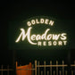 The Golden Meadows Resort illuminated signage at night